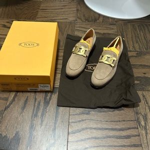 Tod’s Light Brown Suede Loafers with Gold Hardware.